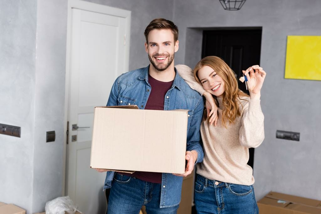 joyful woman holding keys after moving