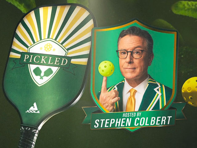 A photo of Stephen Colbert with a pickleball wrapped around his finger and a big green Joola pickleball paddle.