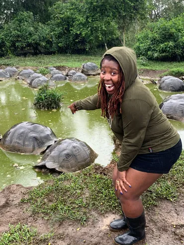 Photograph of Grace pointing at some turtles