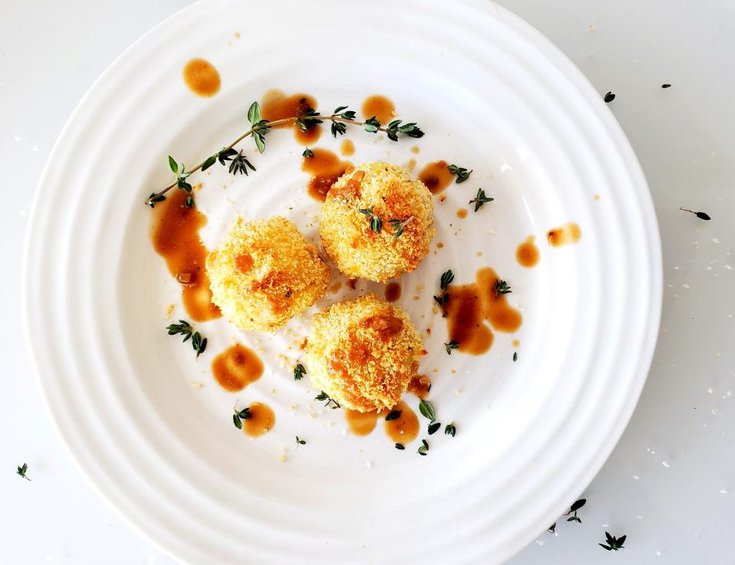 Three mashed potato balls drizzled with gravy