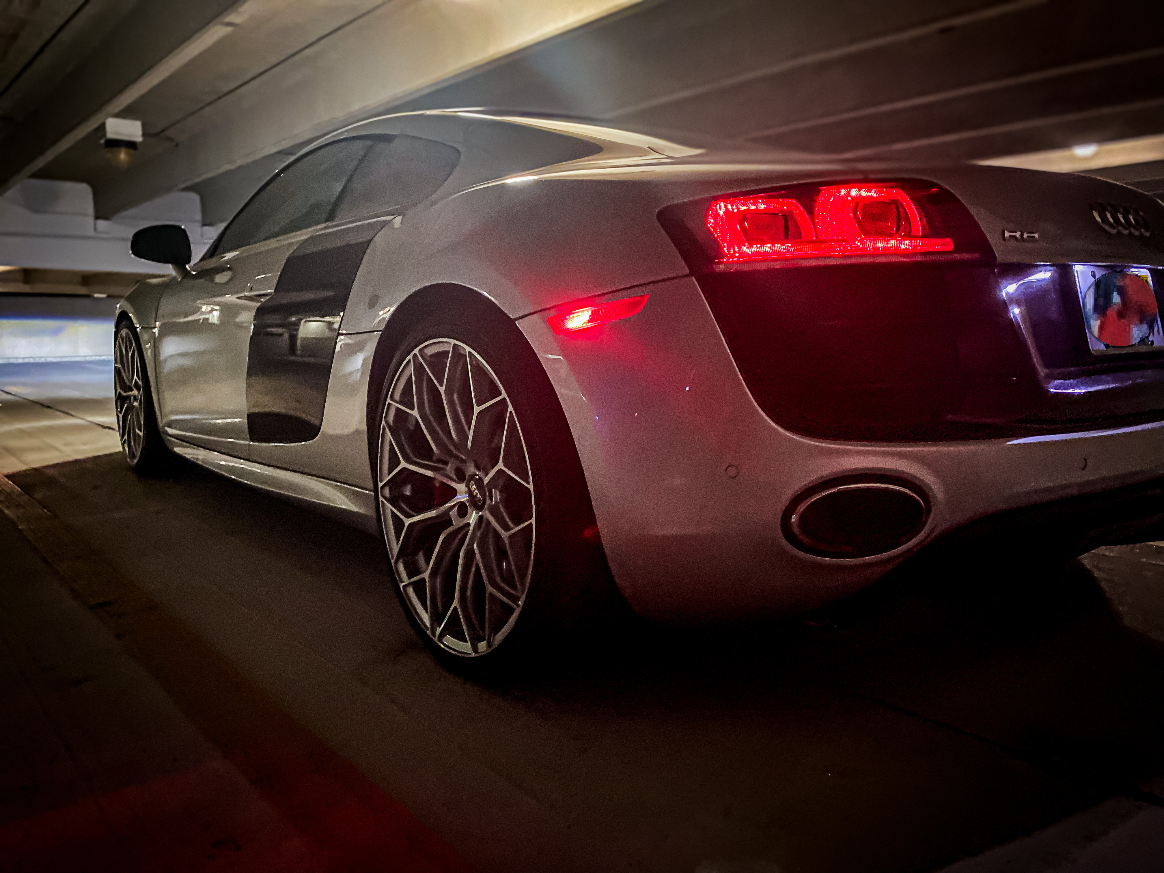 Rear driver side view of Audi R8 in a parking garage