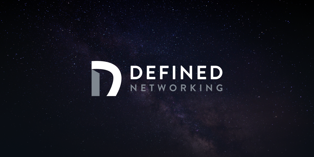 The Defined Networking wordmark over a deep space nebula.