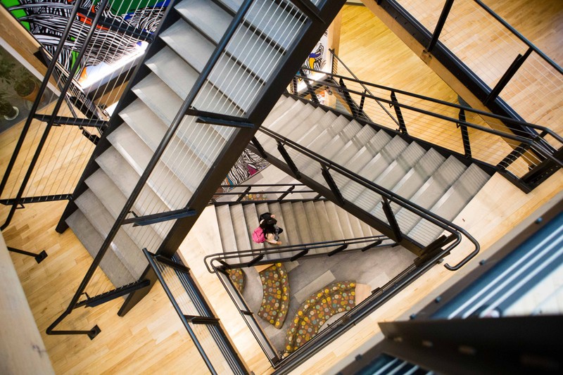 Central staircase connecting floors at Tuft University's Collaborative Learning and Innovation Complex