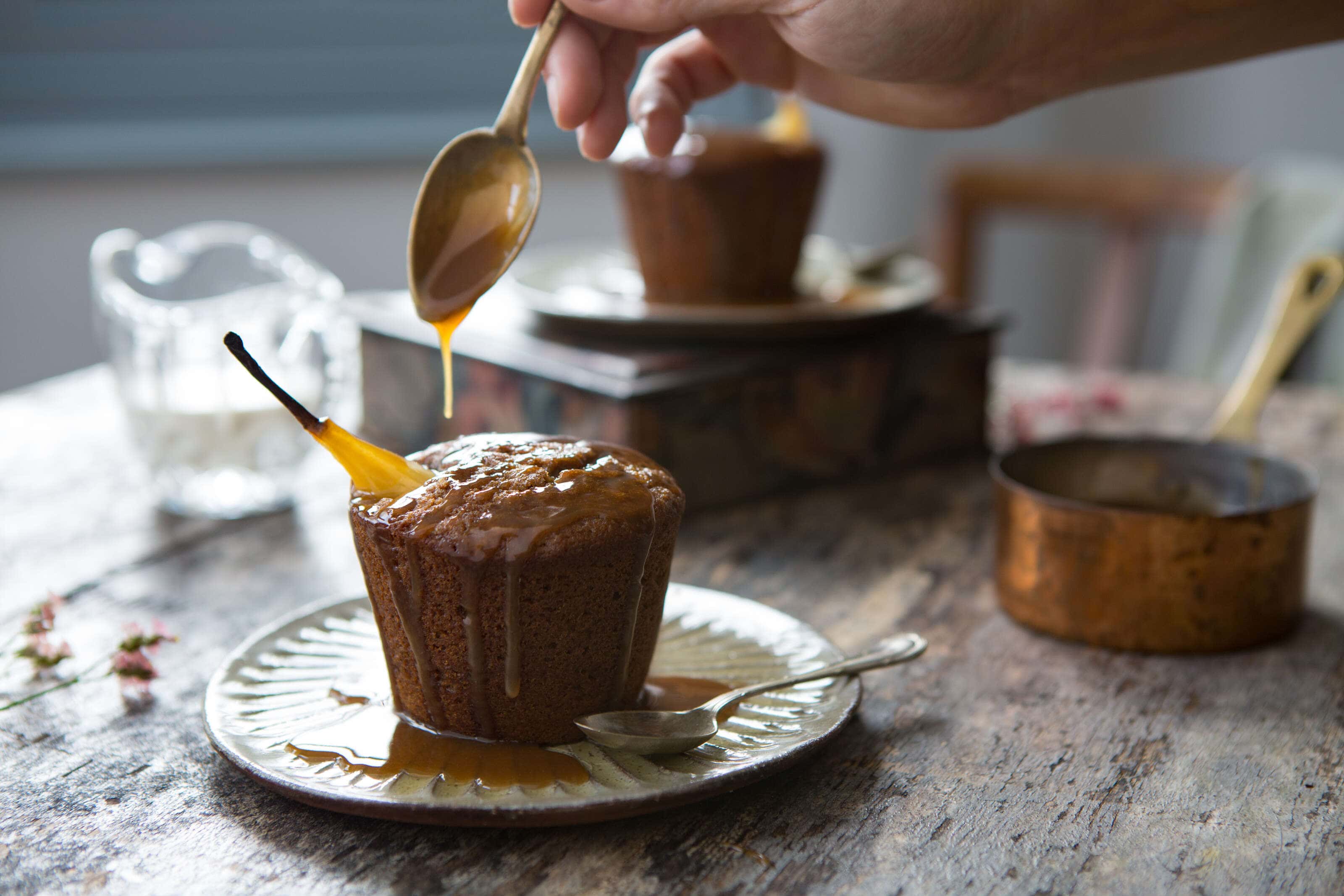 pear and cardomon cake being drizzled with Caramel sauce.