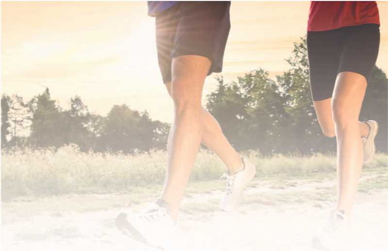 Joggers running in black shorts and a red and blue shirt Joggers running in black shorts and a red and blue shirt