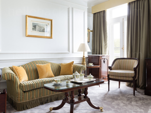 Ornate classic style living room with large sofa and wooden coffee table with glass top Microsoft Teams background