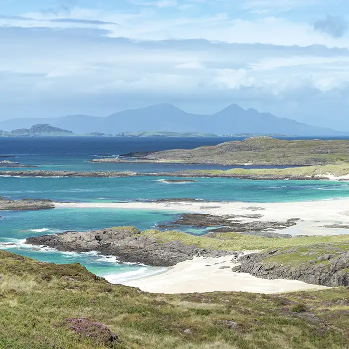 Sanna Bay, on the western coast of the Ardnamurchan peninsula, Scotland. The Isle of Rùm is in the background to the left, while the Isle of Eigg is to the right