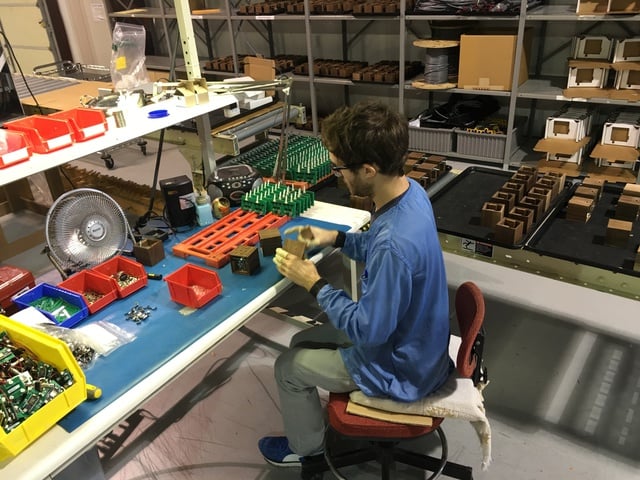 Worker assembles clocks