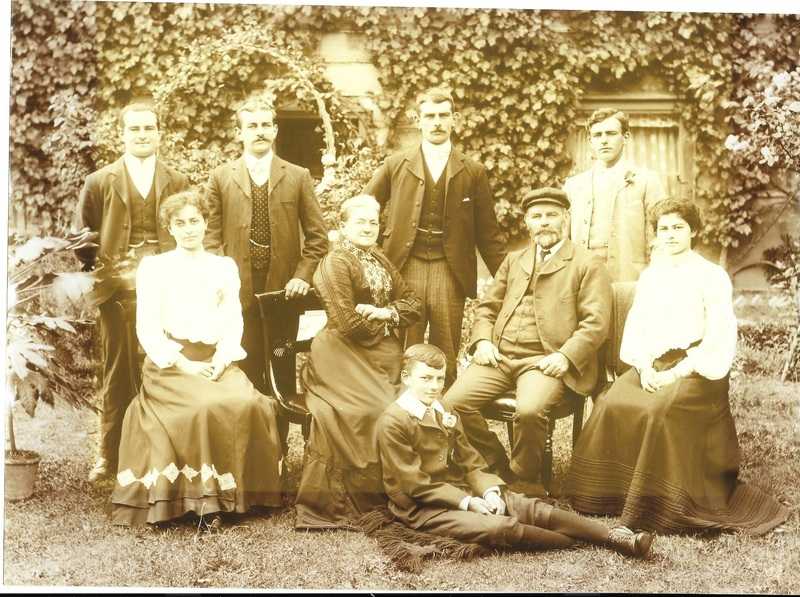 William's son Thomas (seated centre row) his wife Mary on his right.   His sons (back row left to right) William, Charles. Thomas, Fred.   Seated on grass George.   His daughters centre row left Louise right Emily.