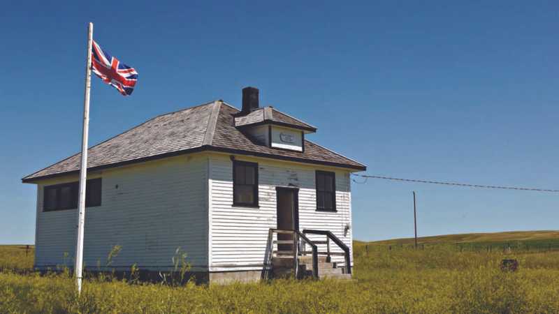 One room school house with a british flag beside