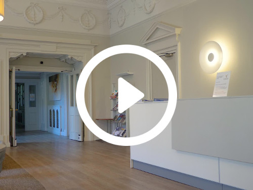 Spacious private office with ornate white cornice above decorative doorways and wooden floor Microsoft Teams background