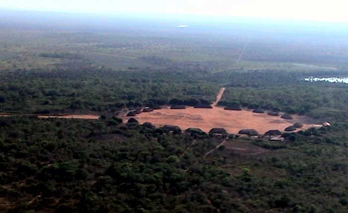 An aerial shot of the Kuikuro settlement with its circular plaza and domed houses along the perimeter.