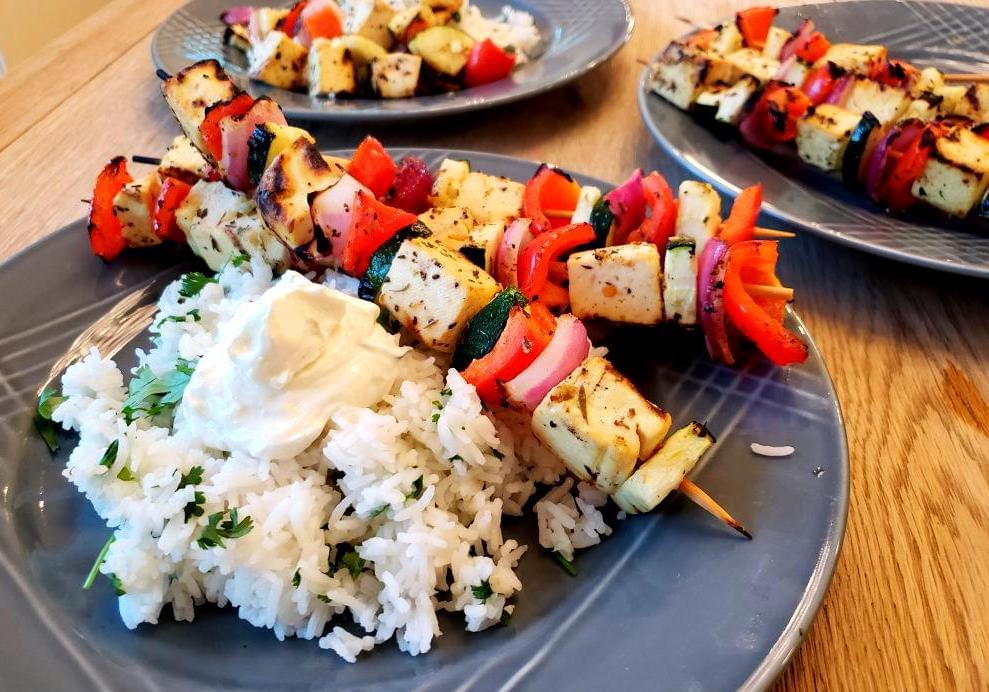 Plate of Mediterranean skewers with tofu and vegtables and side of rice