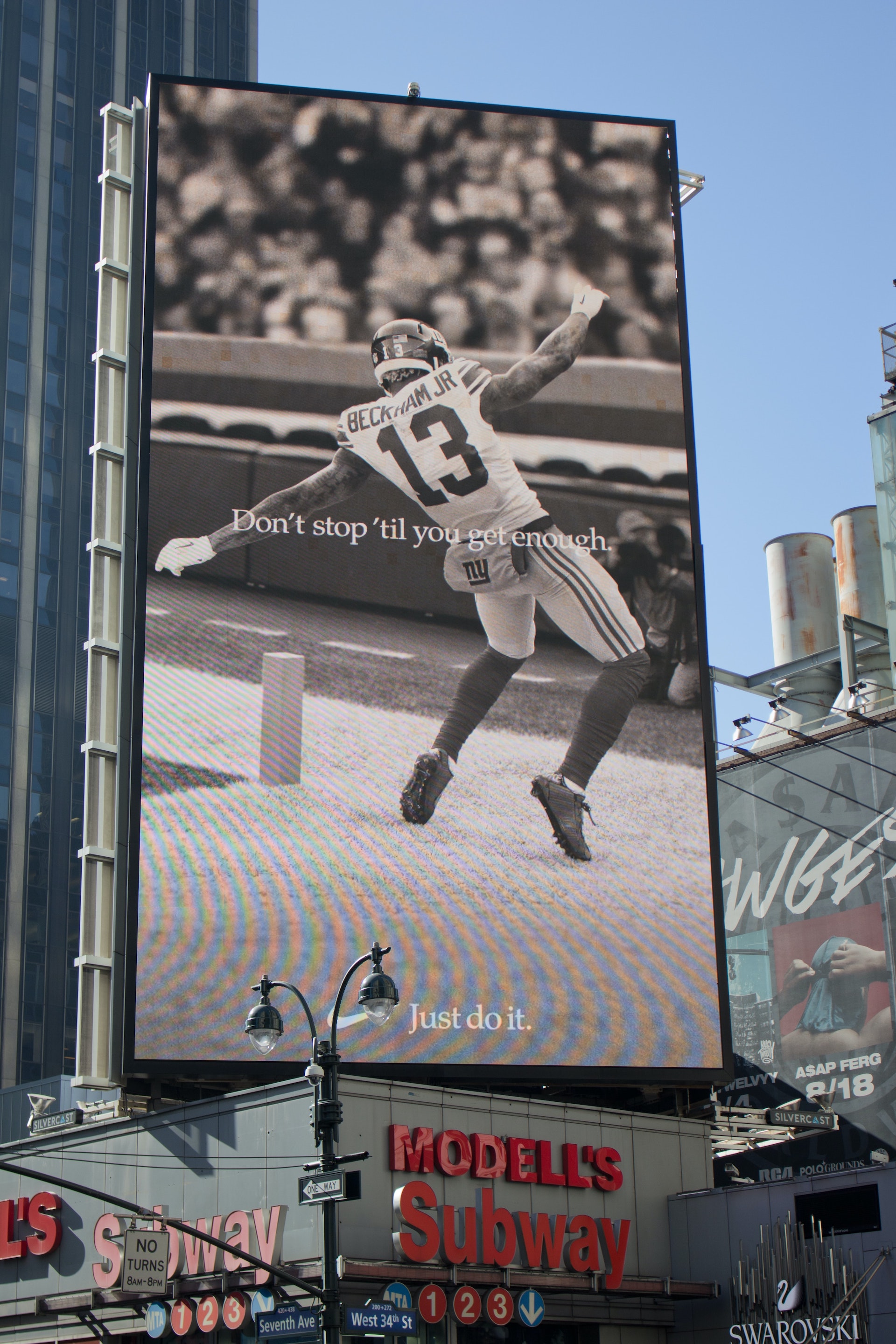 Billboard with a football player celebrating a touchdown on it.