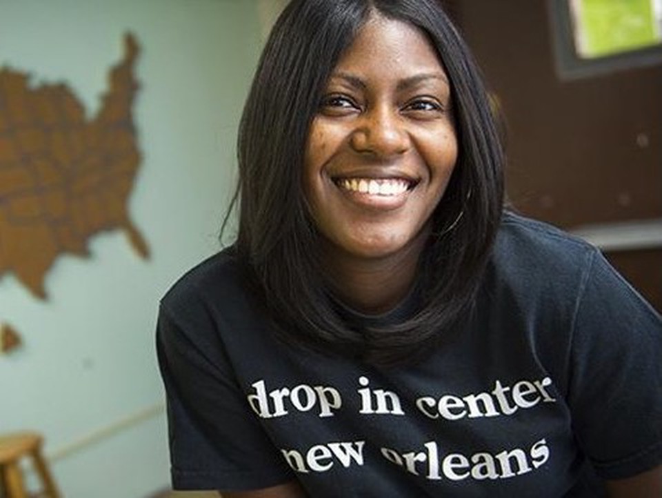 A woman in a black t-shirt smiling