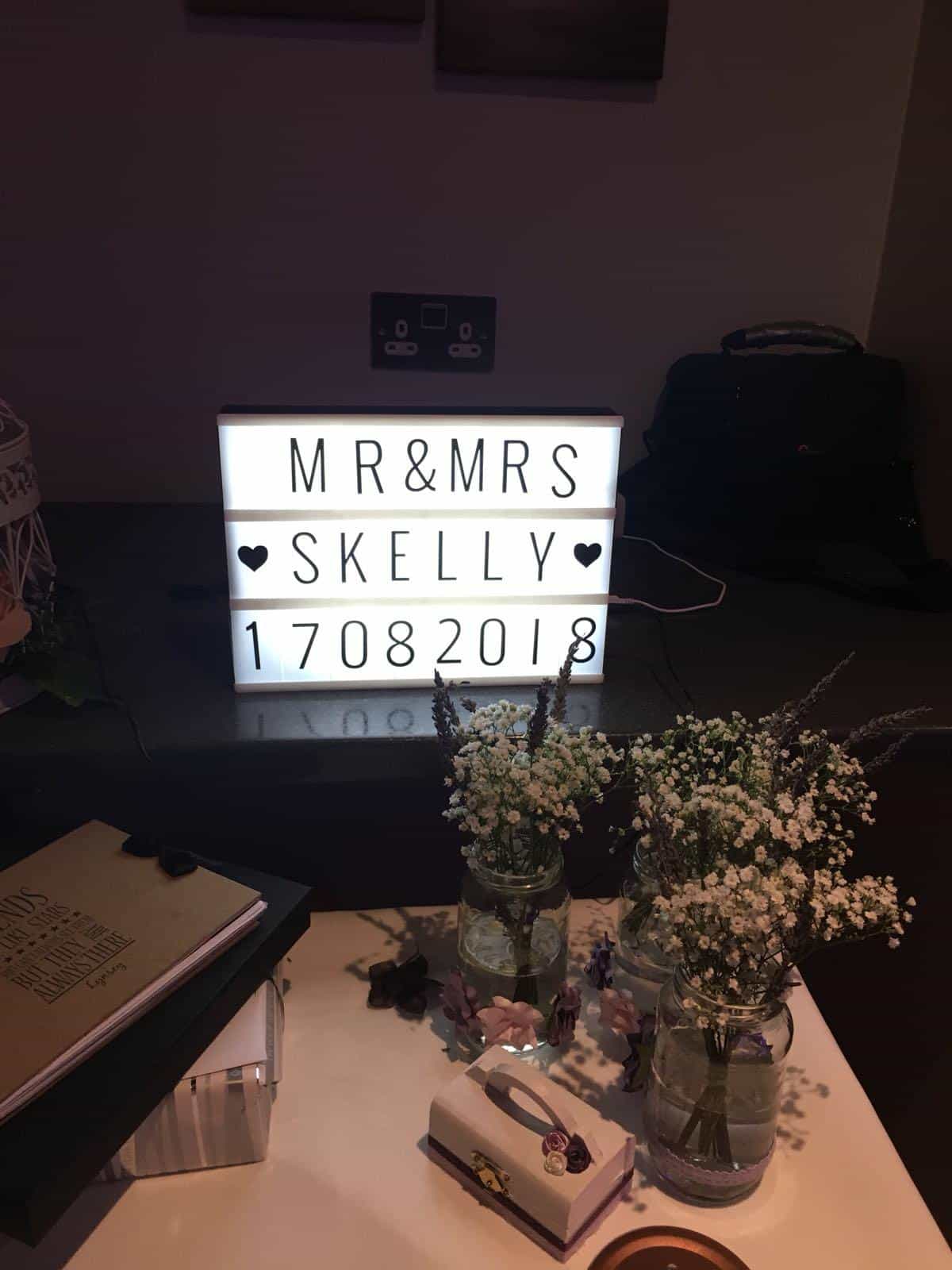LED letters spelling out 'Mr & Mrs Skelly 17082018' on a table