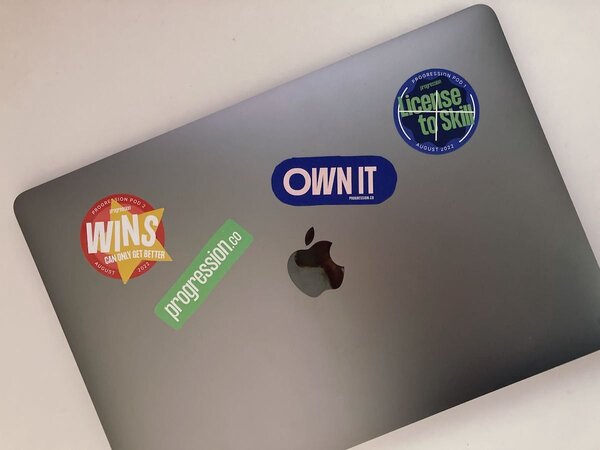 Photo of laptop covered in our Pod branded stickers