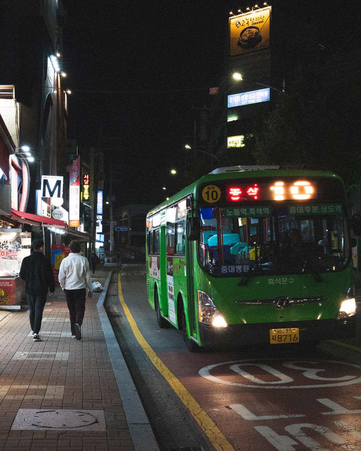 Bus during midnight in Heukseok-dong, people strolling