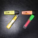 Four highlighter pens, each pair making a seven, the pair of sevens making seventy seven.