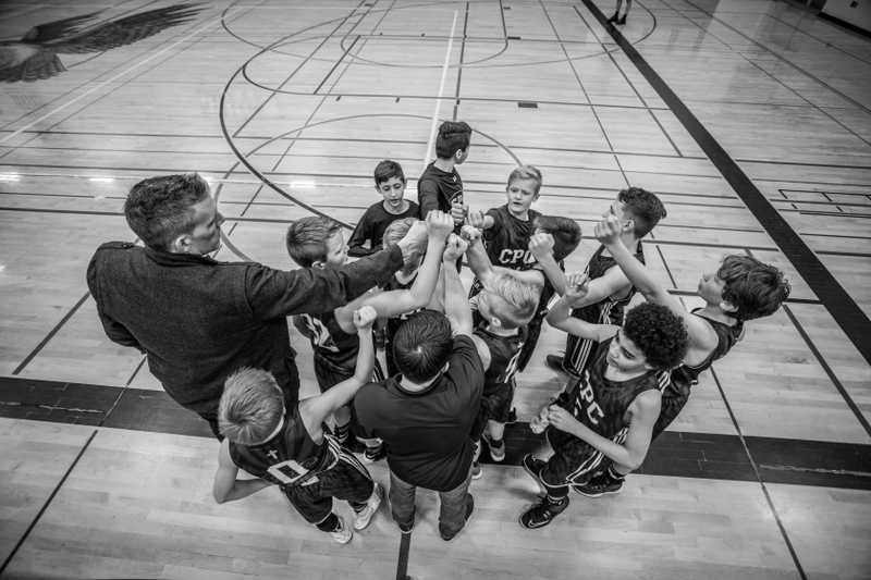 Photo of a kids basketball team coming together.