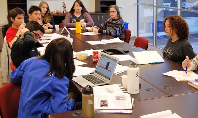 Young adults meeting during a high school giving circle
