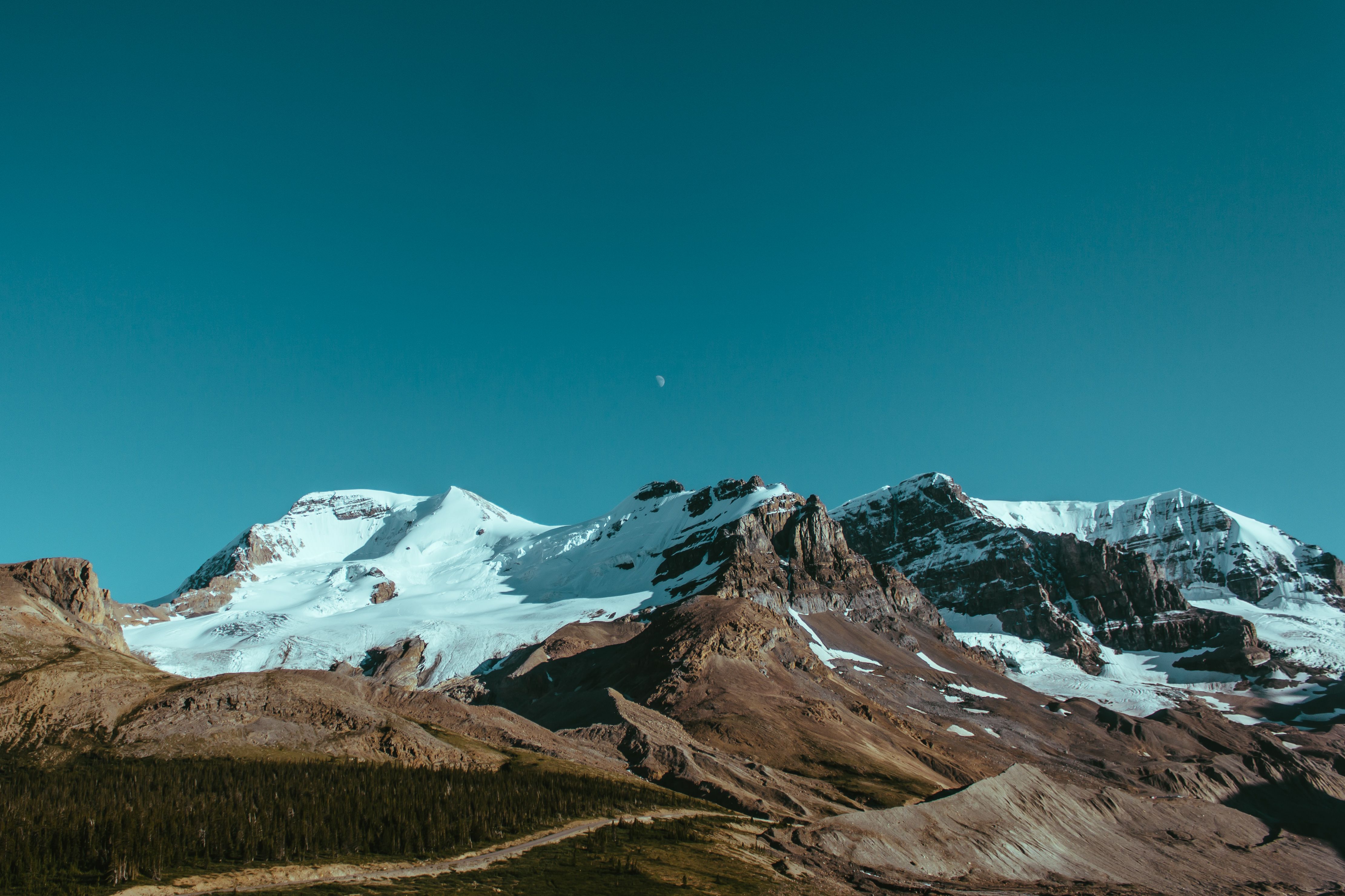 Alpine mountains under a clear sky by Ryan Schroeder