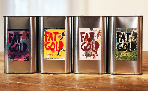 tin containers of olive oil with colorful labels