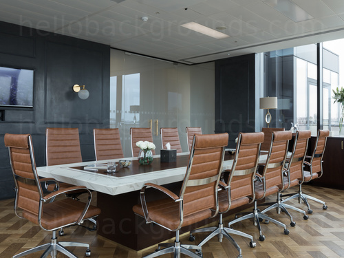 Retro meets modern style board room featuring marble table with flower arrangement and orange leather chairs Zoom background