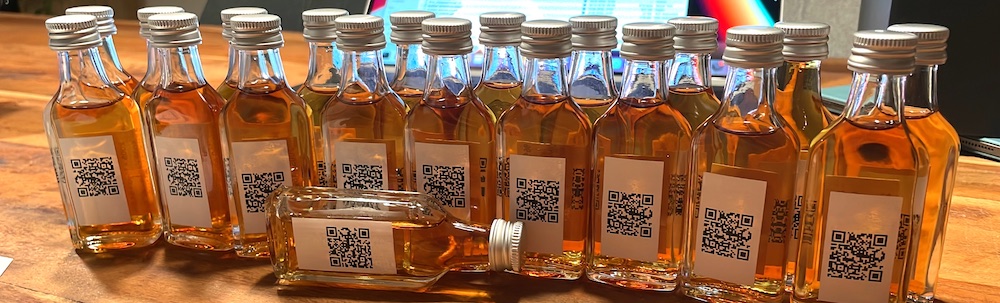 Filled sample bottles with RumX QR codes as label