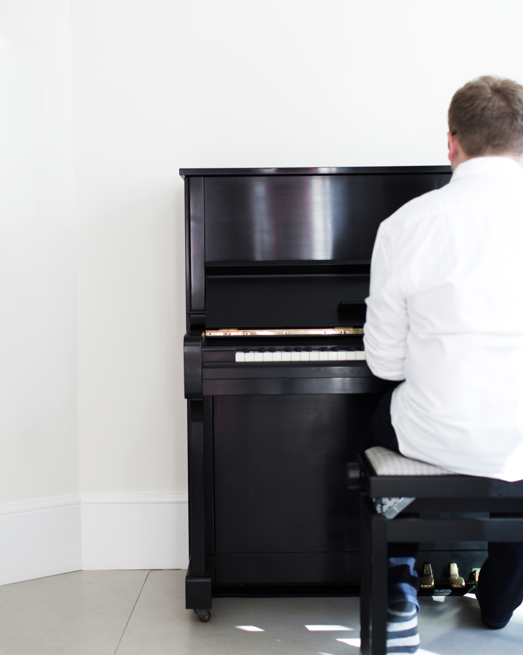 Jack Watkins playing an upright piano