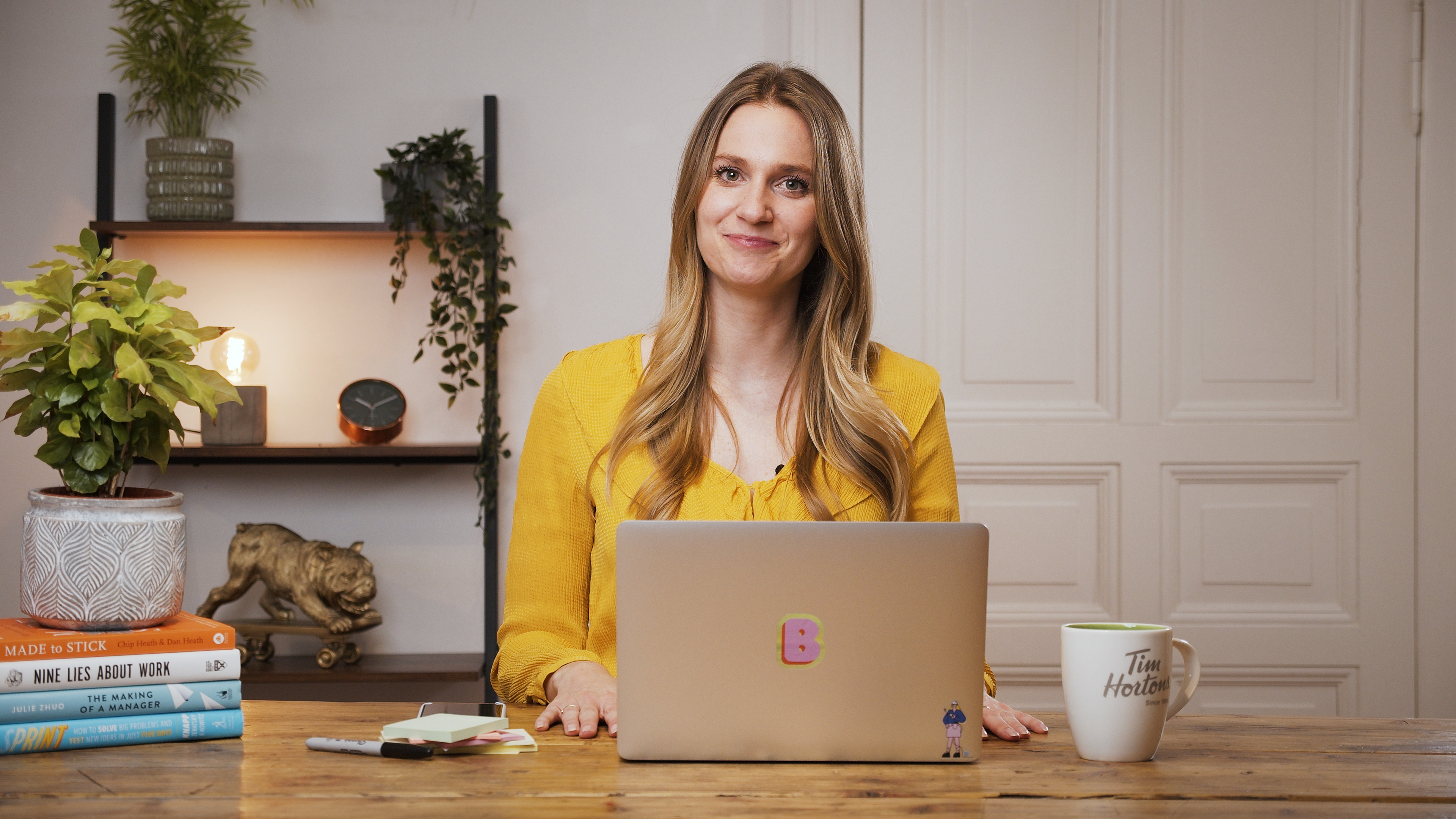 How to build a personal brand for your tech career Brittni Bowering, content strategist and branding expert, sitting at a desk, smiling