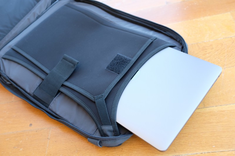 The laptop compartment has a very slick design, you slip in your laptop both vertically (from top) or horizontally (from the side).