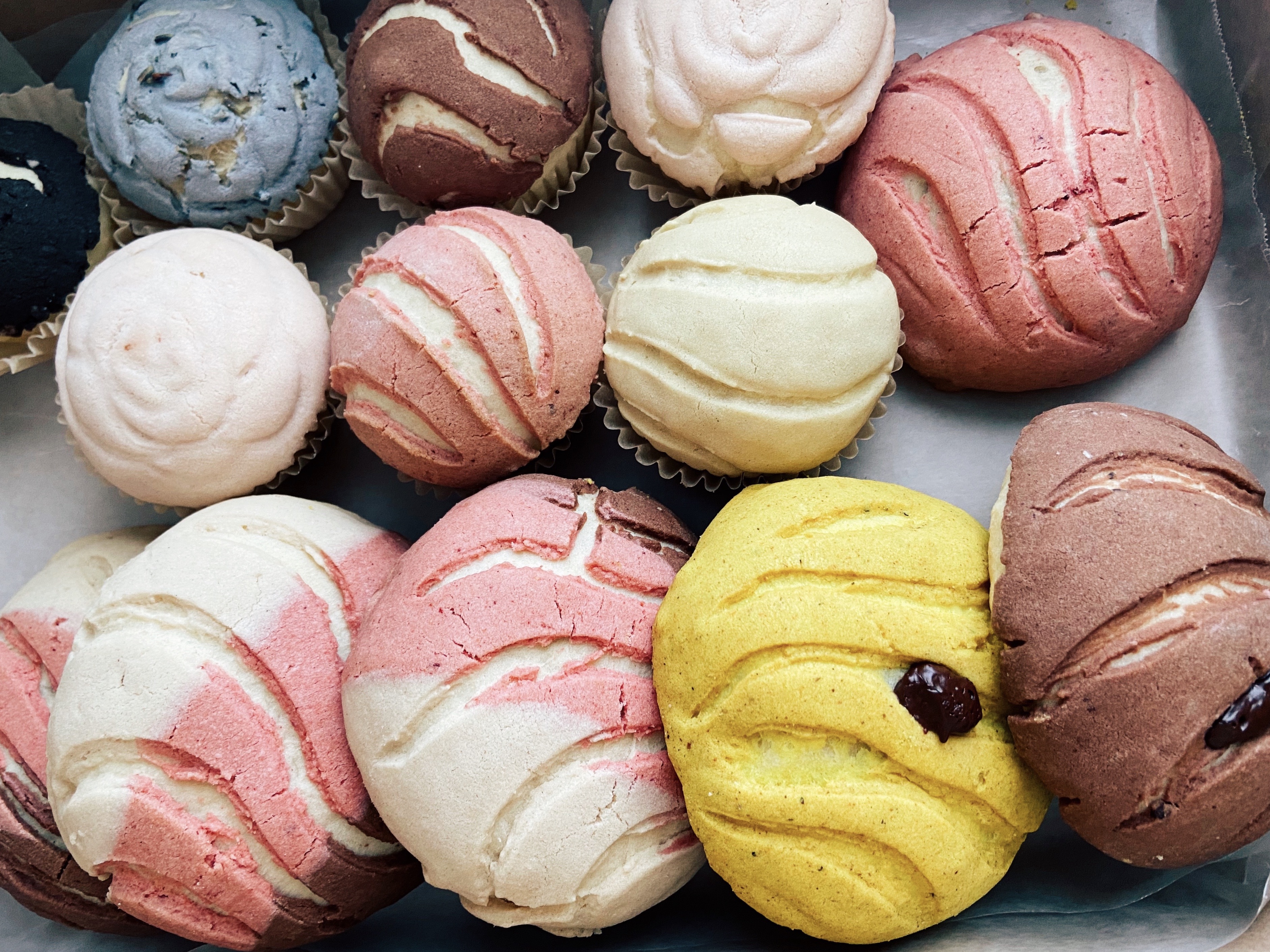 an asortment of colorful conchas