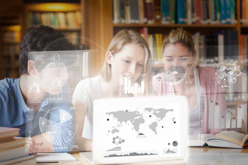 Three young adults looking at a laptop screen.