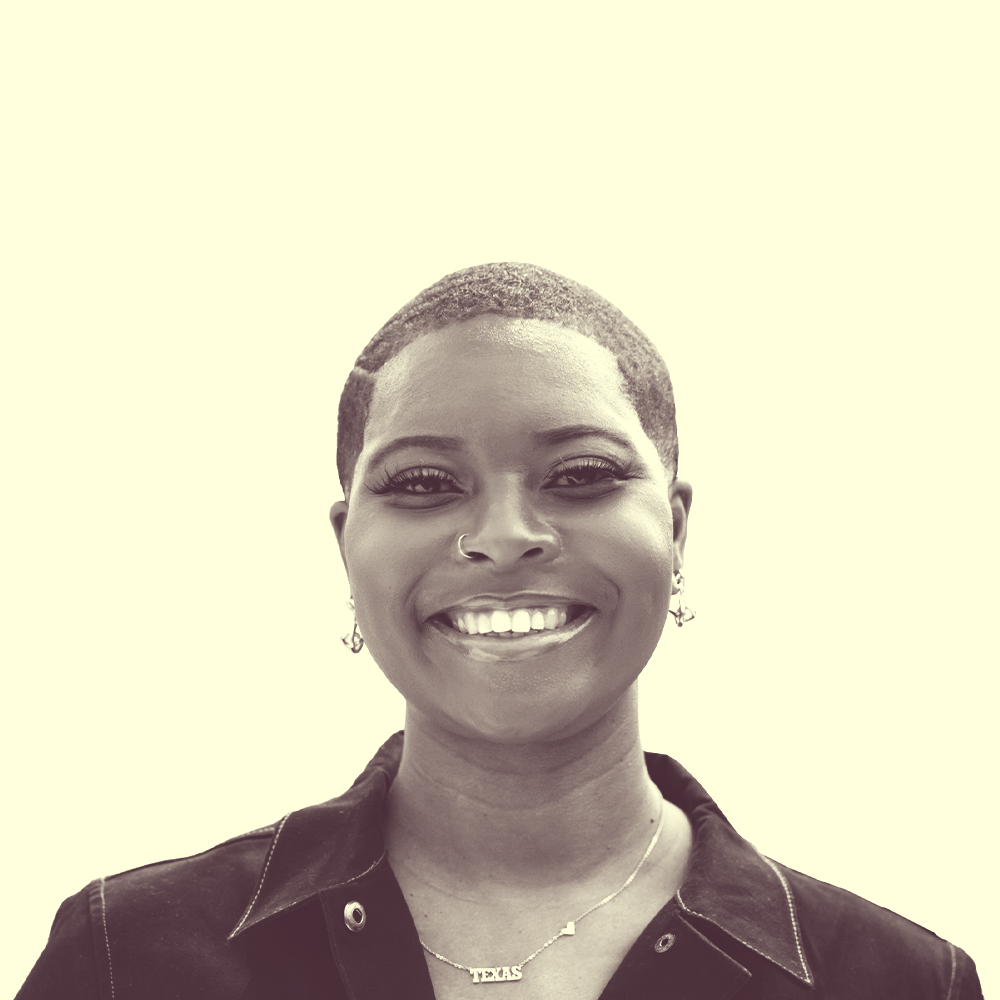 A black woman with a fade haircut smiling