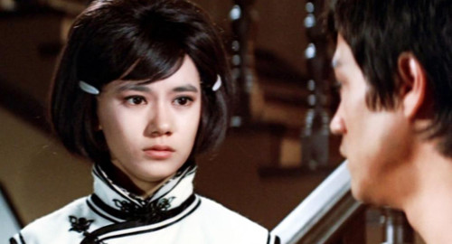 A close-up screenshot from the movie 'Fist of Fury' of a young woman worriedly looking a young man who is slightly off-camera.