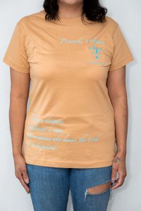 an orange blessed and redeemed shirt, with blue text on it reading a bible quote