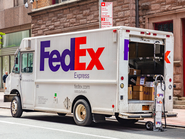 A FedEx truck stopping to make deliveries of packages and alcohol