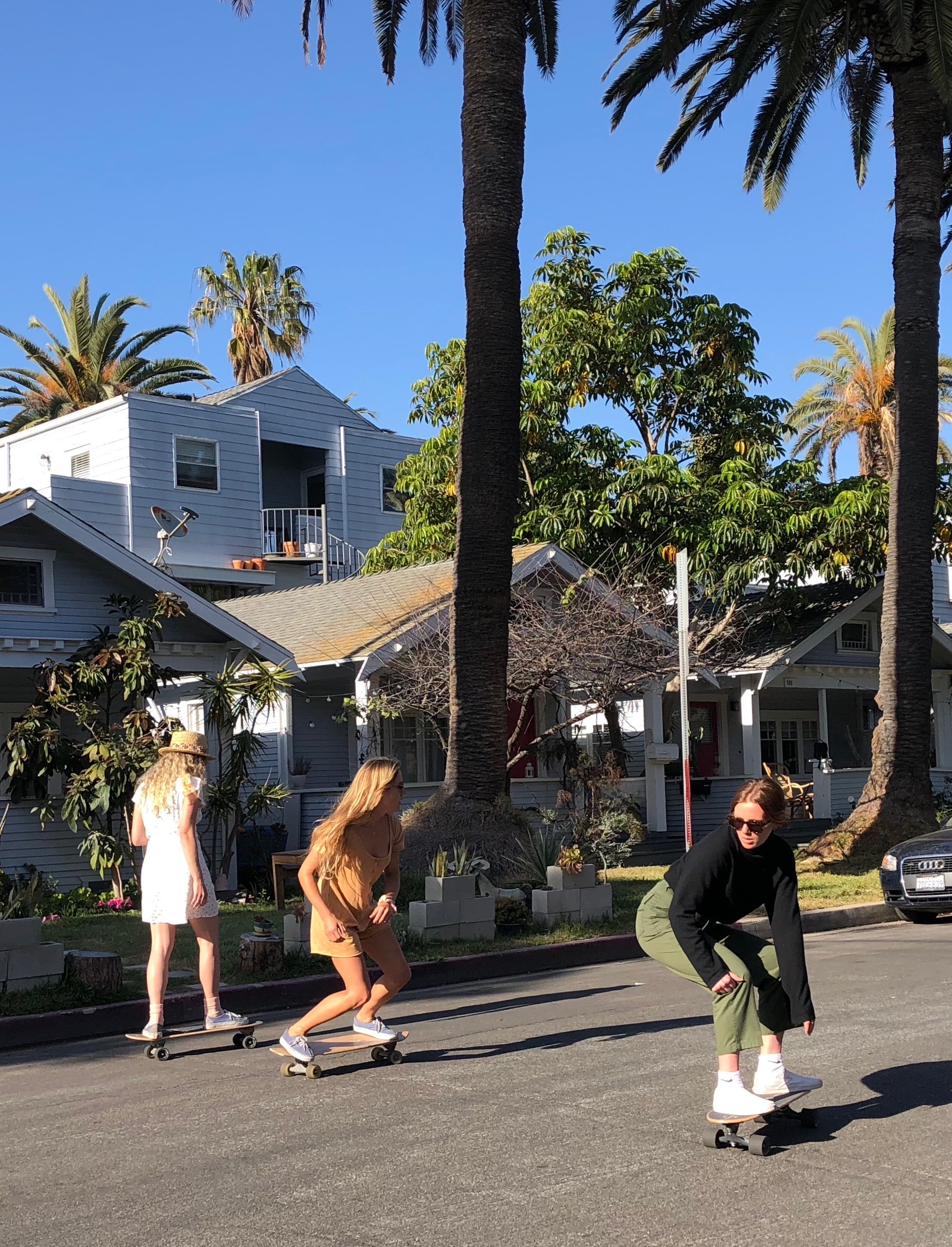 Girlswirl skateboarding down the street