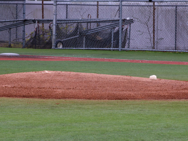 A pitcher's mound with a rosin bag laying on it.