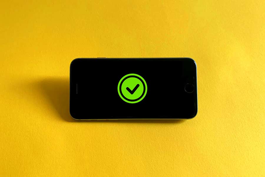 Phone displaying a green check mark icon