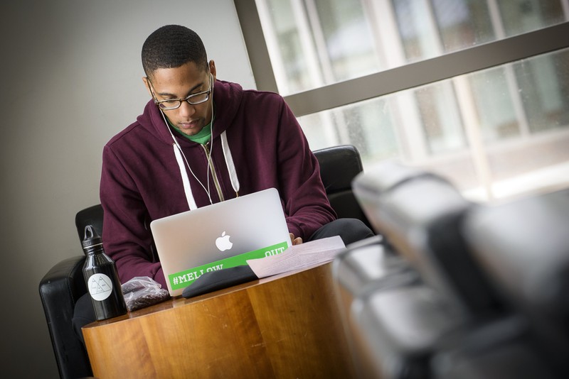 Norfolk State University student working on a laptop