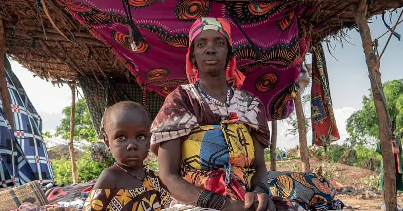 Woman with her two children at an unofficial IDP site in the Centre North region of Burkina Faso