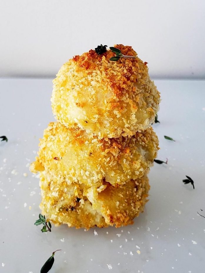 Three mashed potato balls stacked ontop of eachother