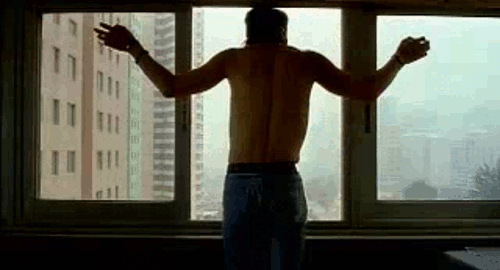 An animated gif of a scene from the film 'Quitting' with a forward tracking shot of Jia Hongsheng sticking his head out of a window as his arms stretch out.