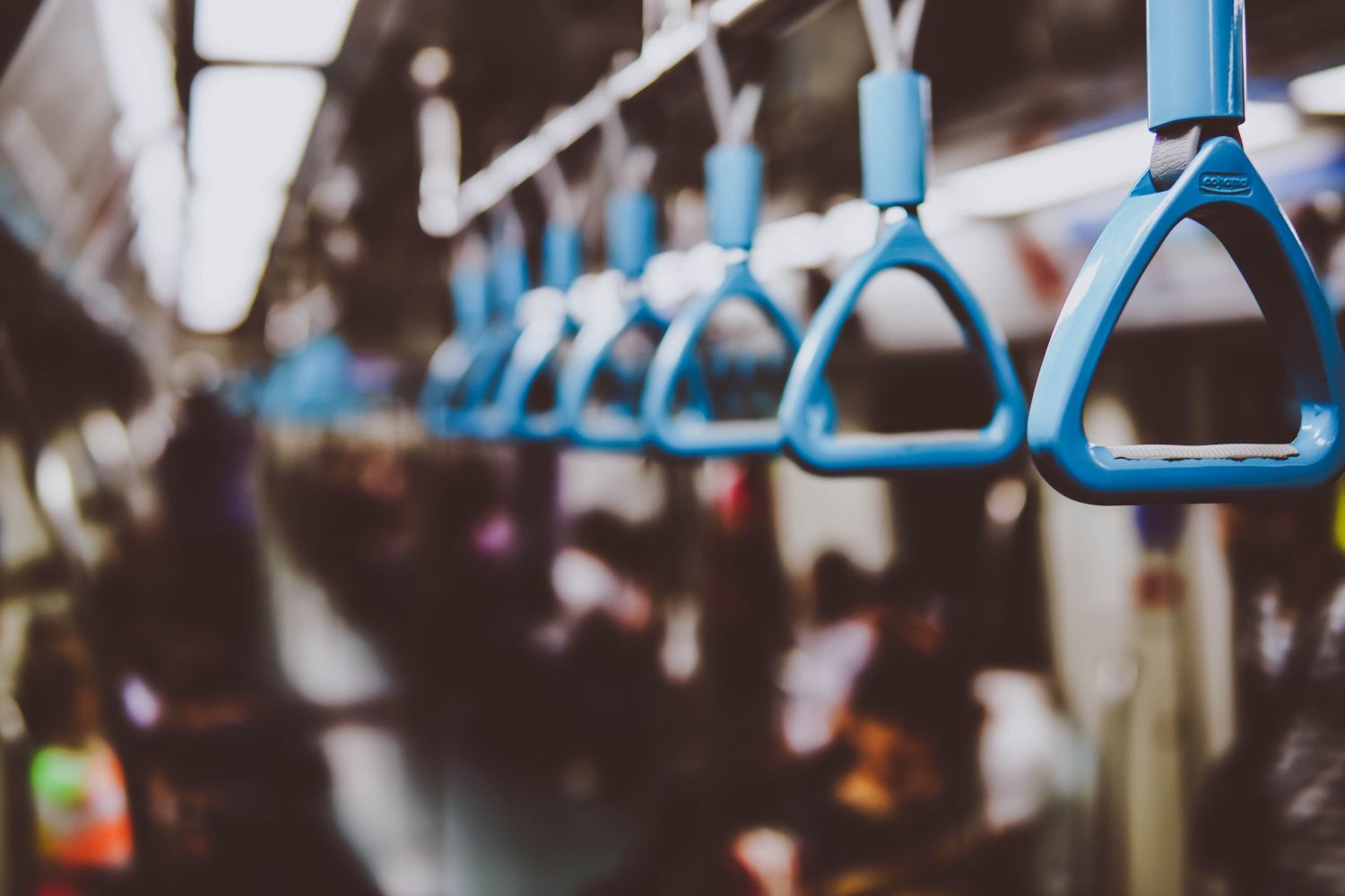 Handles for standing subway passengers, from close to far away.