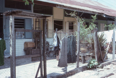 A fenced dirt yard of a kampong house at Potong Pasir.