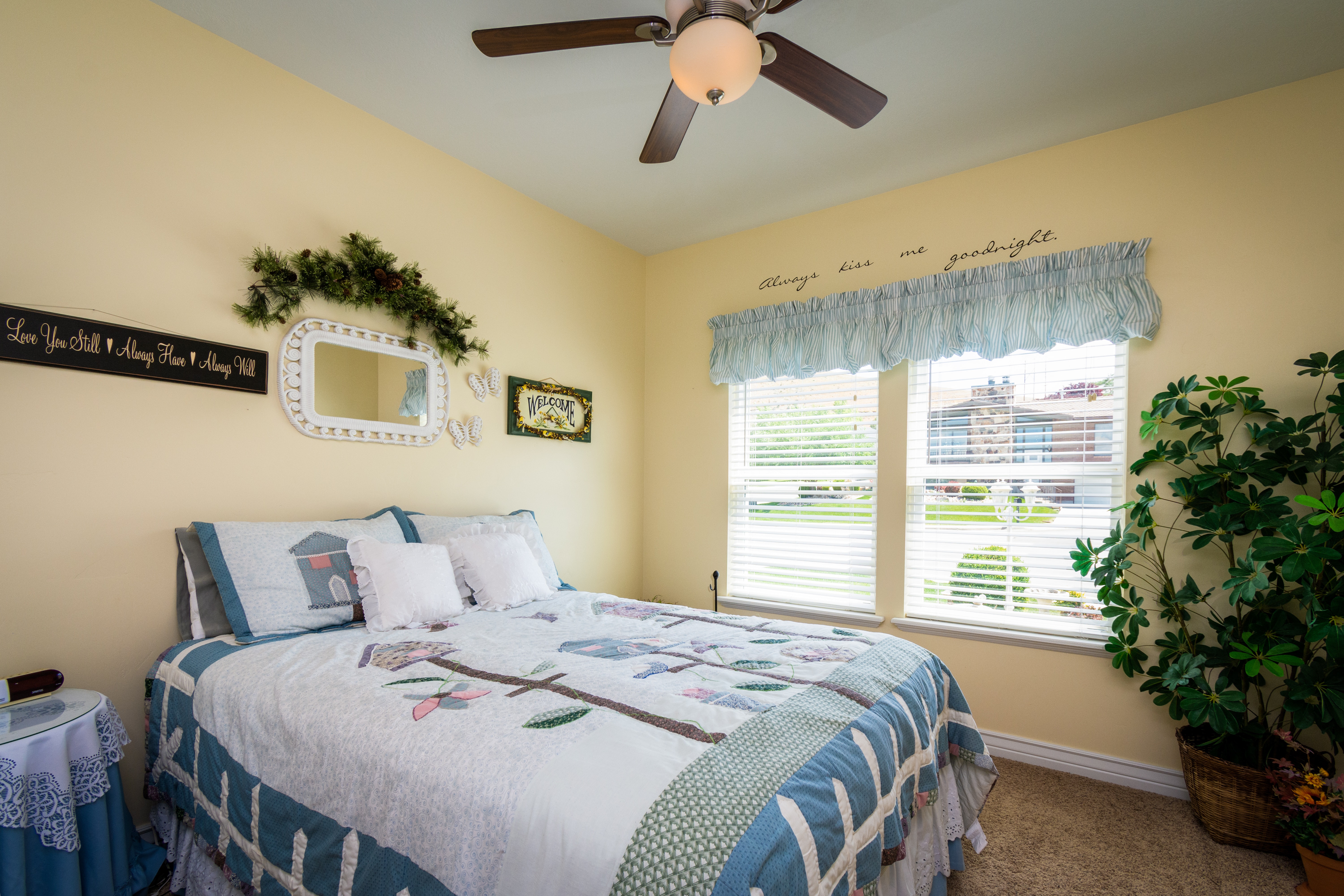 a bedroom with a blue and white-striped valance