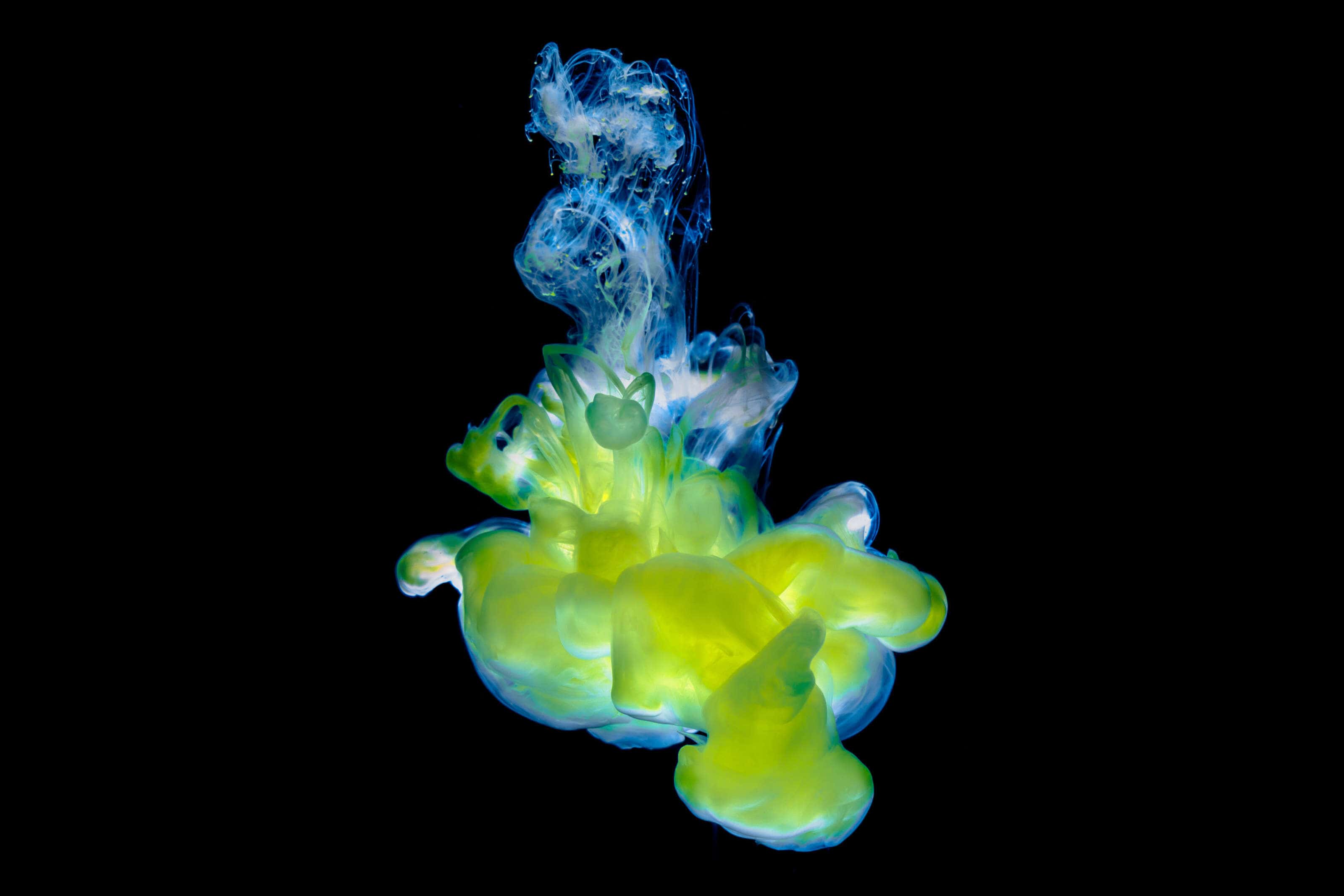 yellow liquid forming a cloud in water