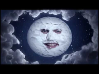 Moon with man's face surrounded by clouds
